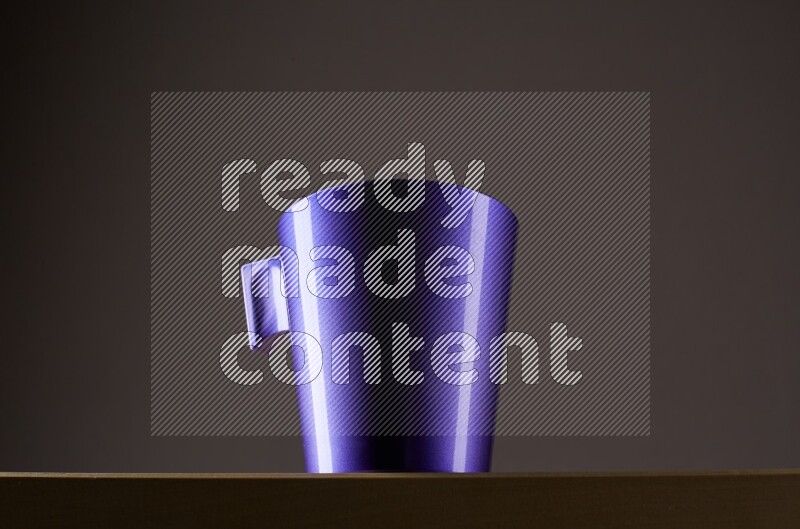 Low angle shot of a purple cup on grey background