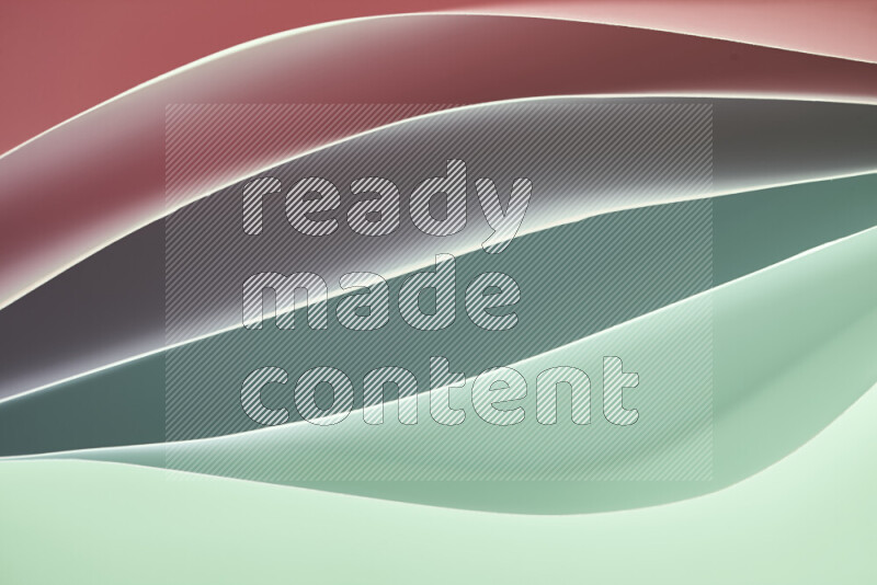 This image showcases an abstract paper art composition with paper curves in green and red gradients created by colored light
