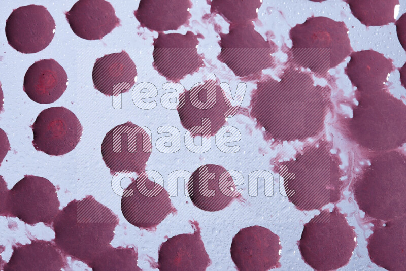 Close-ups of abstract purple paint droplets on the surface