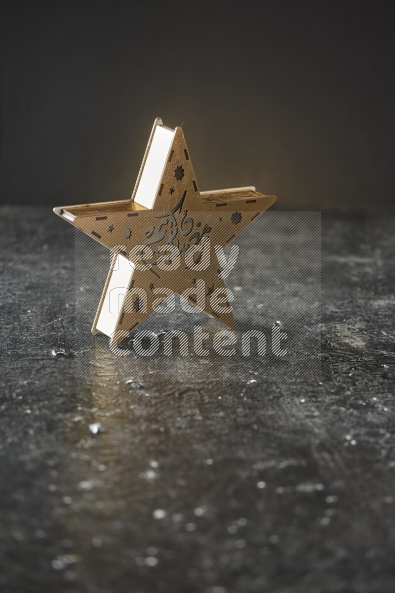 A lantern placed on a textured black background