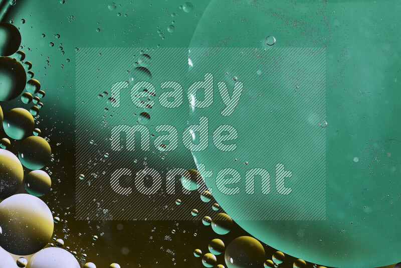 Close-ups of abstract oil bubbles on water surface in shades of green, black and yellow