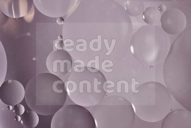 Close-ups of abstract oil bubbles on water surface in shades of grey