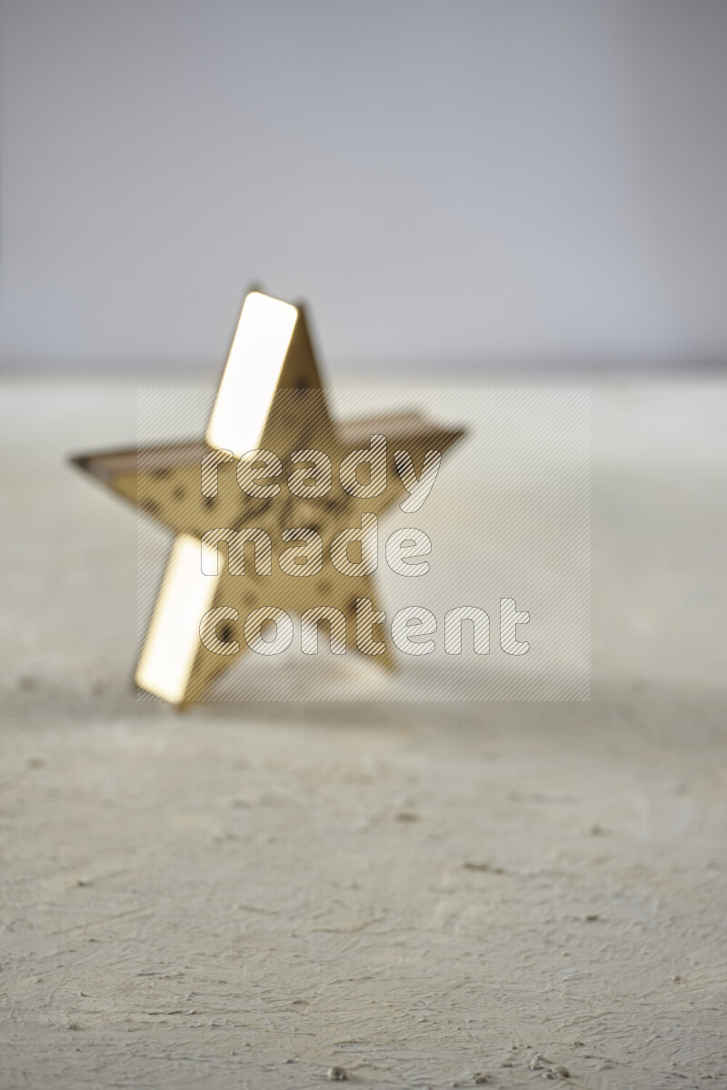 A lantern placed on a textured white background