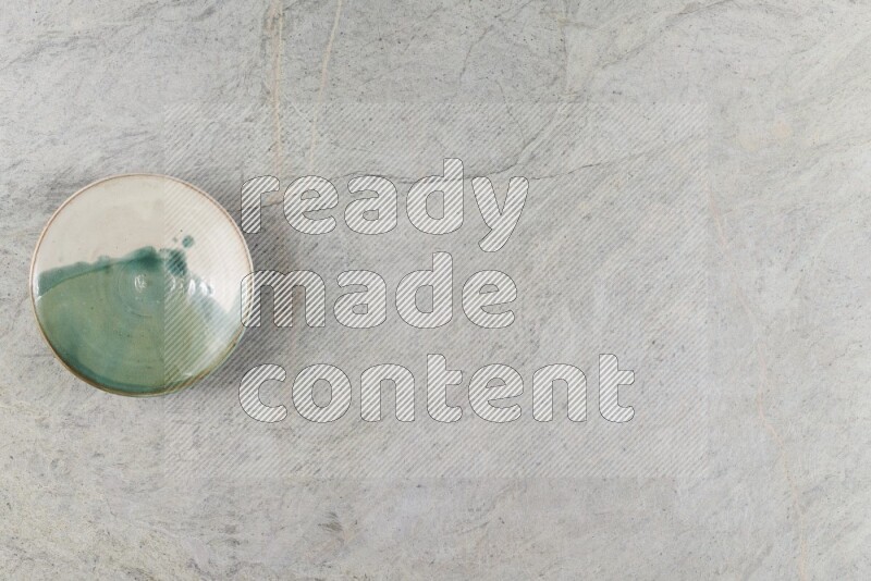 A multicolored pottery Bowl on grey marble background