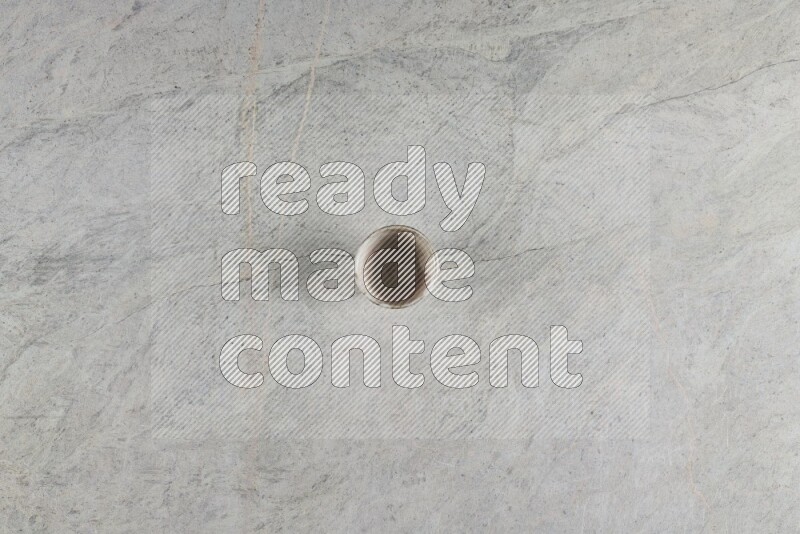 A multicolored pottery Cup on grey marble background