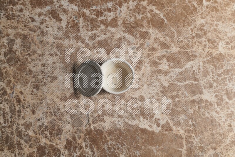 A pottery cup on beige marble background
