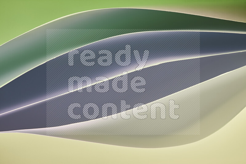 This image showcases an abstract paper art composition with paper curves in green and different warm gradients created by colored light