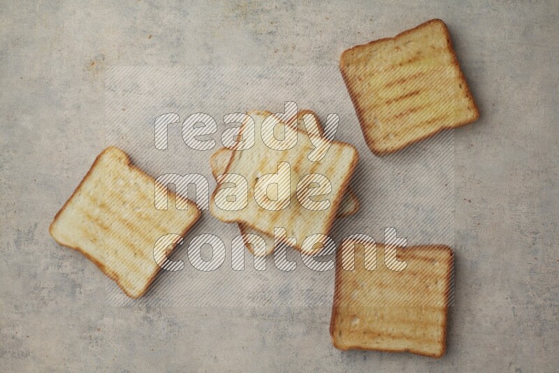 Toasted White Toast slices with a butter curl on a light blue textured background