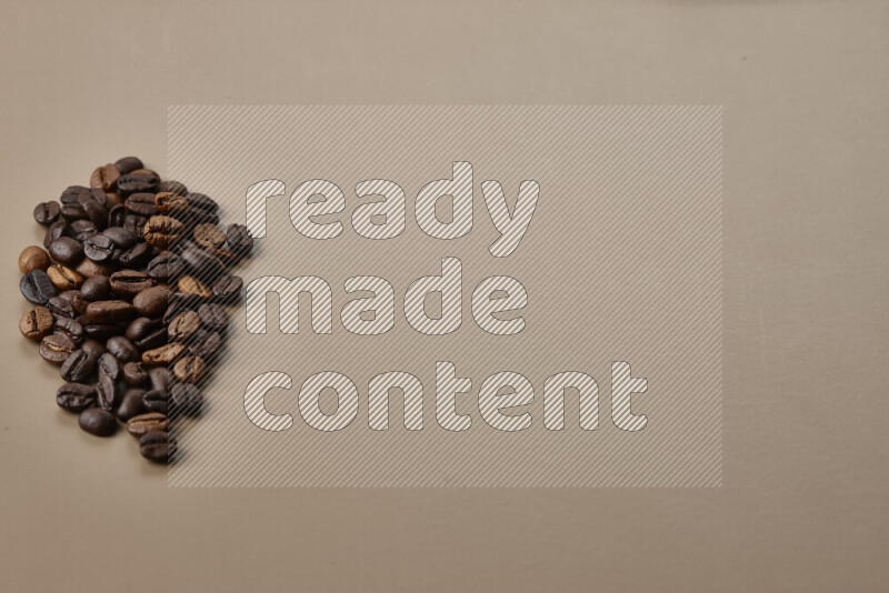 Assorted kinds of coffee such as roasted beans and ground on beige background