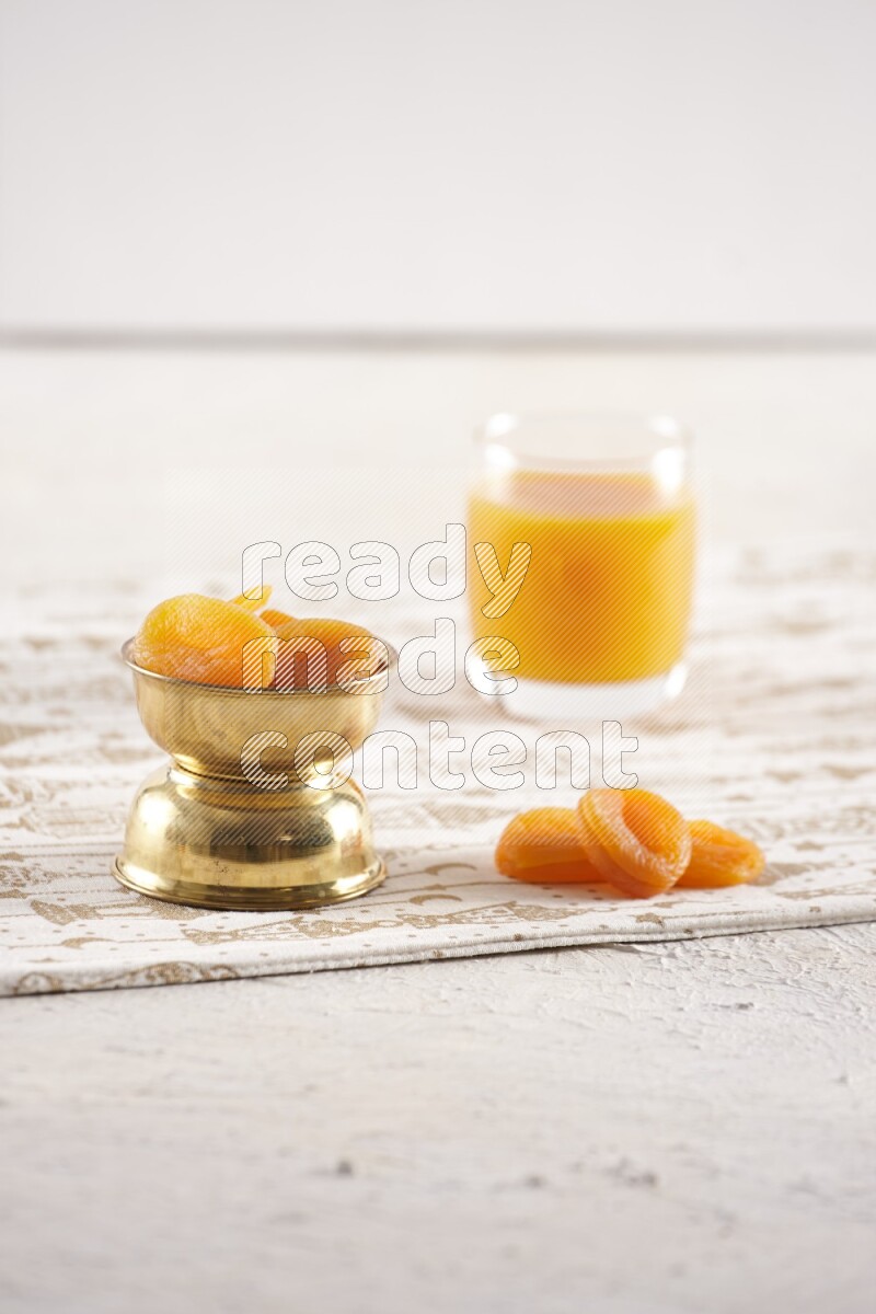 Dried fruits in a metal bowl with qamar eldin in a light setup