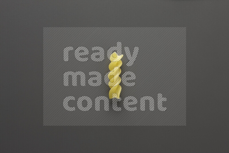 Fusilli pasta on grey background