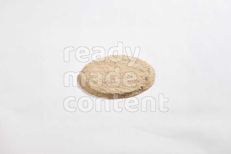 Garlic powder in a circle shape on a white flooring