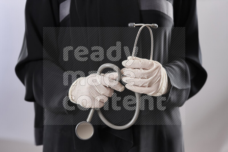 Female doctor wearing an abaya and medical attire in different positions