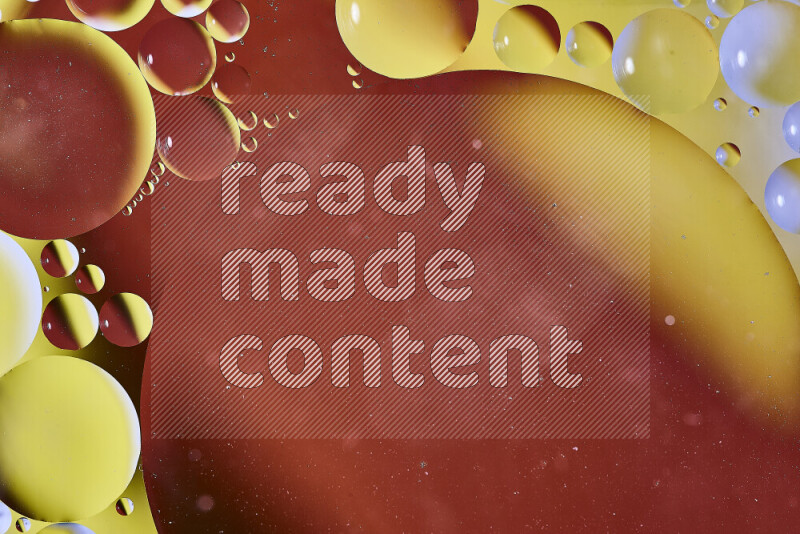 Close-ups of abstract oil bubbles on water surface in shades of orange and yellow