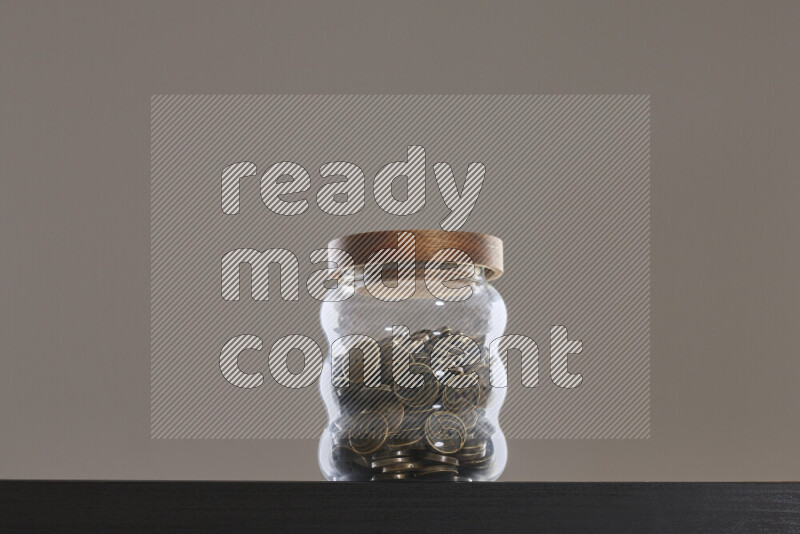 Buttons in a glass jar on black background