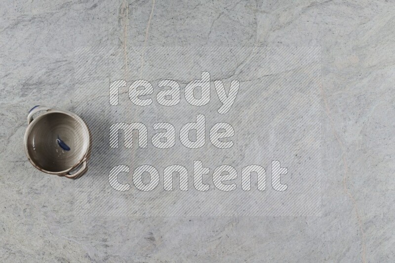 A multicolored pottery Bowl on grey marble background