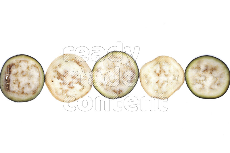 Eggplant slices on illuminated white background
