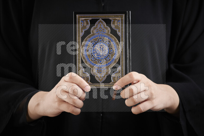 A woman hands holding moshaf in different positions