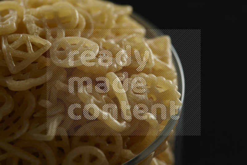 Snacks in a glass jar on black background