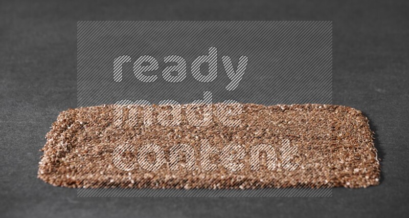 Flaxseeds Filling the Frame on a black Flooring