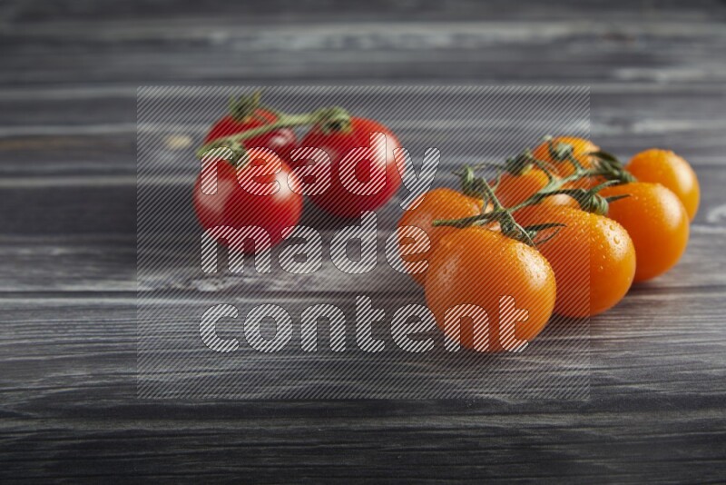 Mixed cherry tomato veins on a textured grey wooden background 45 degree