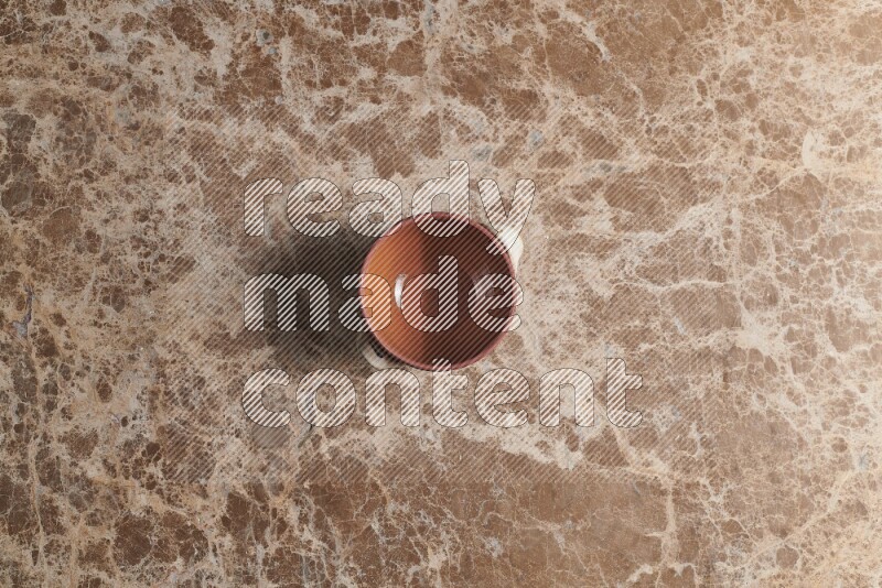A multicolored pottery pot on beige marble background