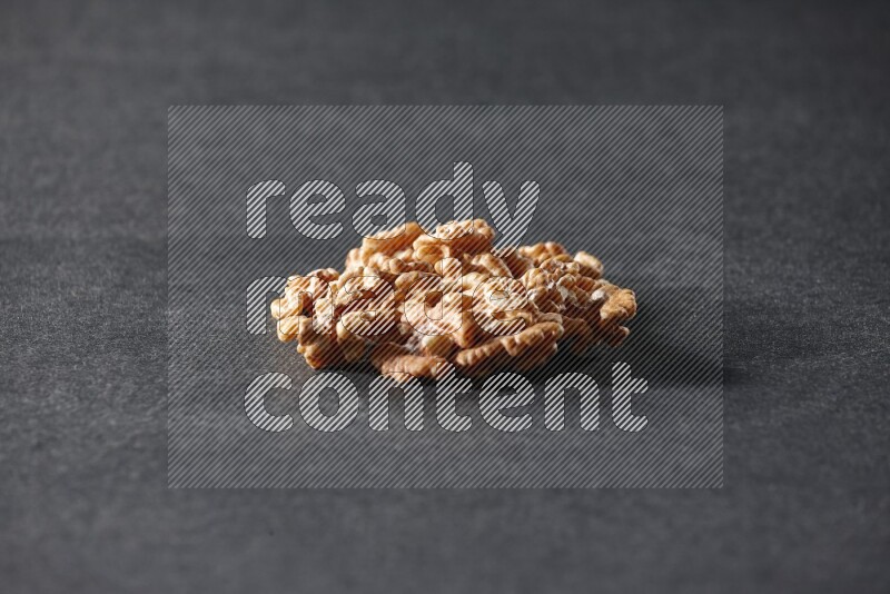 A bunch of walnuts on a black background in different angles