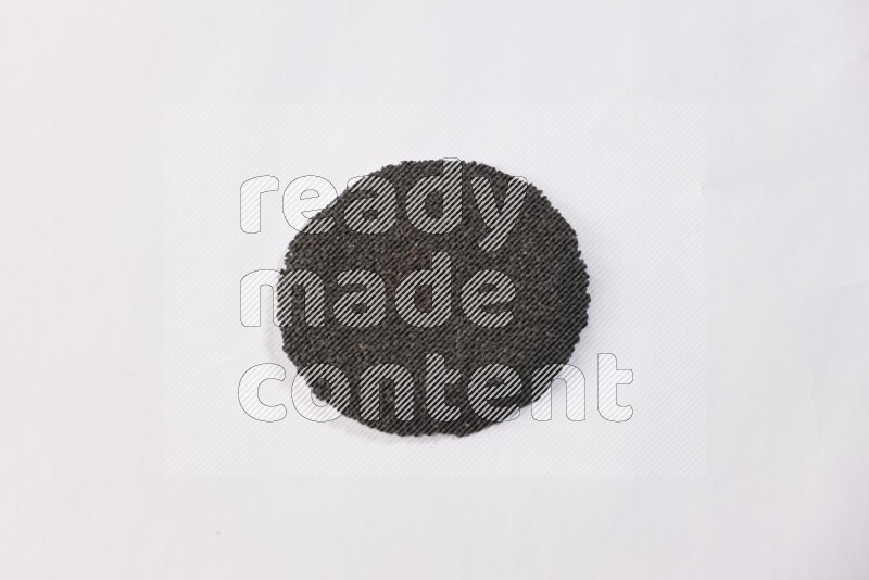 Black seeds in a circle shape on a white flooring