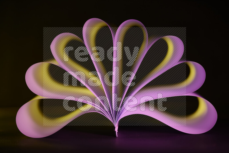 An abstract art piece displaying smooth curves in yellow and pink gradients created by colored light