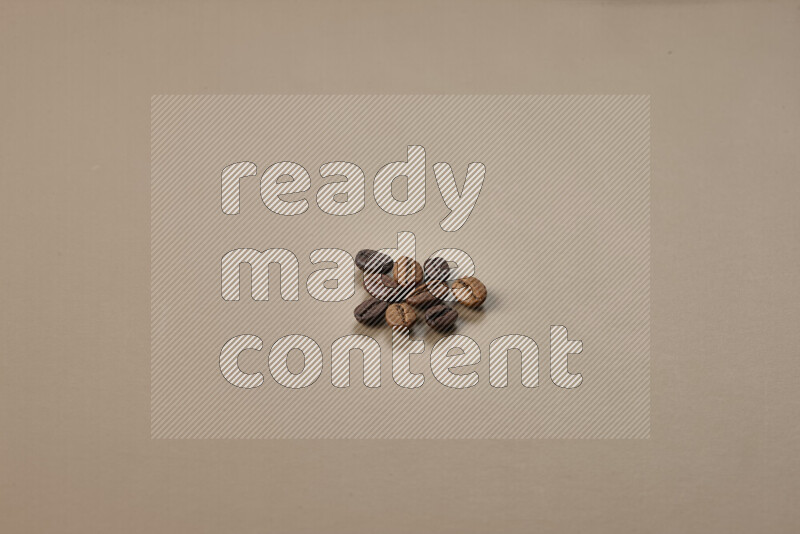 Roasted coffee beans on beige background