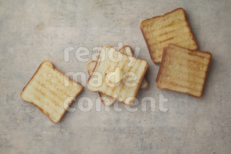 Toasted White Toast slices with a butter curl on a light blue textured background