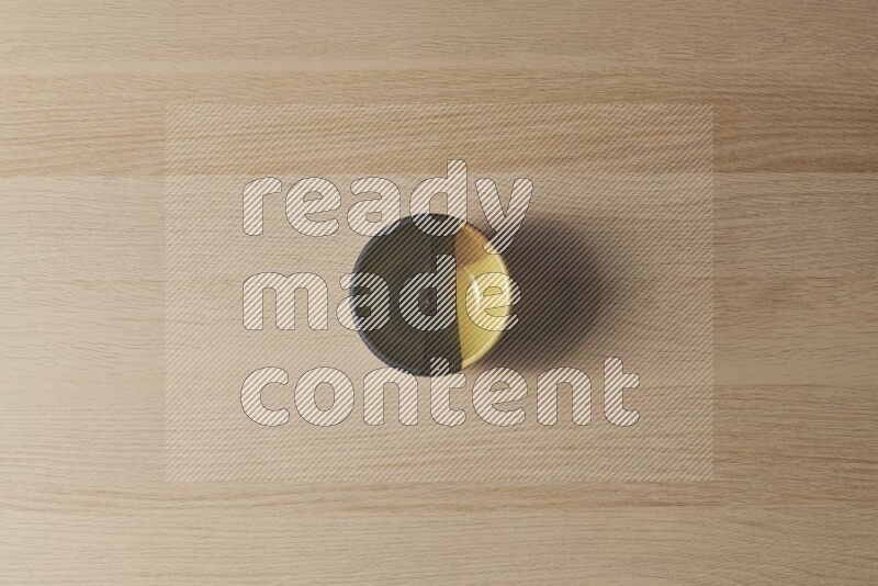A multicolored pottery bowl on light wooden background