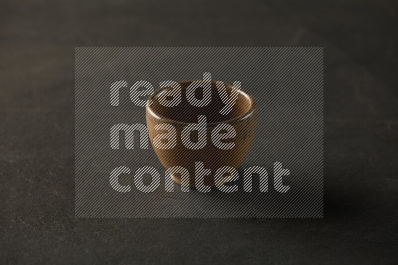 multi color round sauce bowl on grey textured countertop