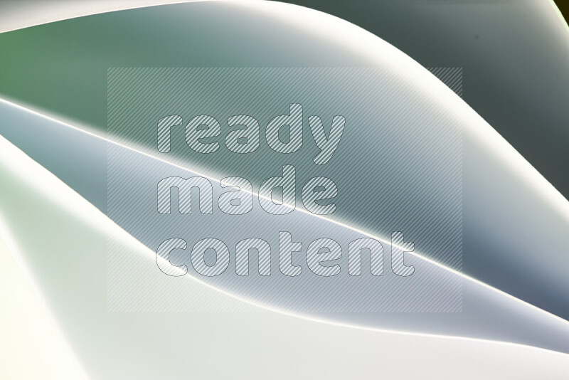 This image showcases an abstract paper art composition with paper curves in green and white gradients created by colored light