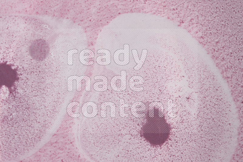 The image captures a dramatic splatter of purple paint over a white backdrop