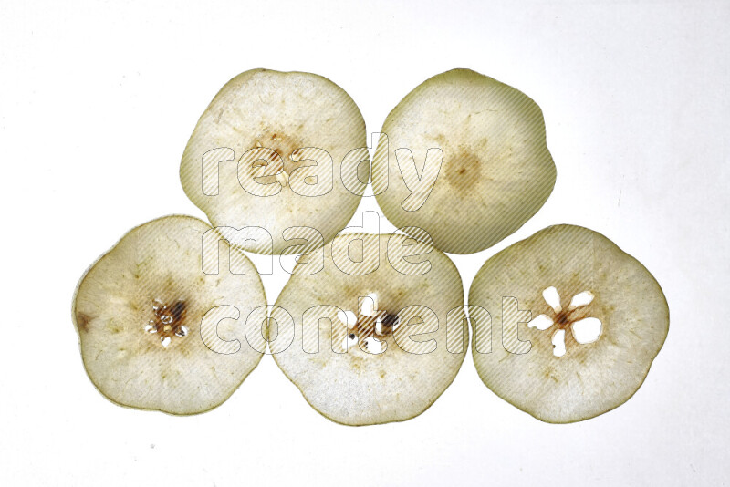 Pear slices on illuminated white background