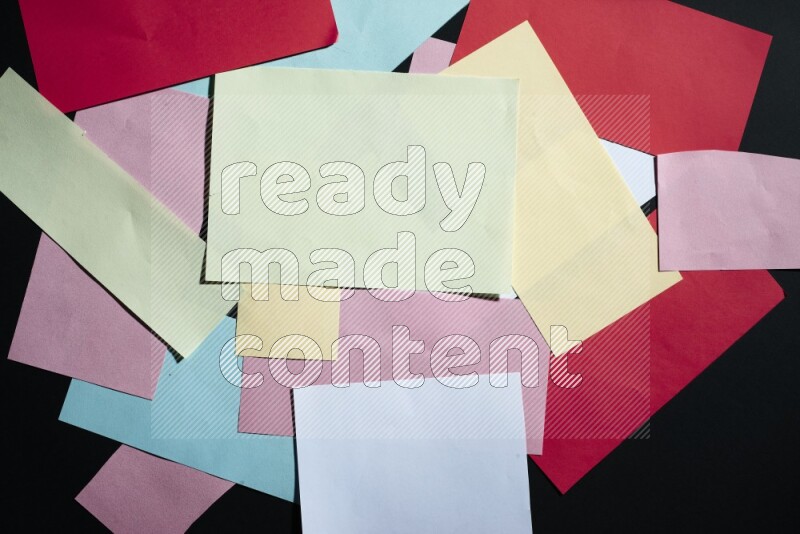 Multicolored paper sheet on black background