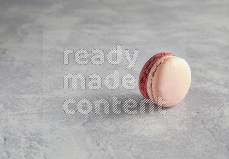 45º Shot of Pink Litchi Raspberry macaron on white  marble background