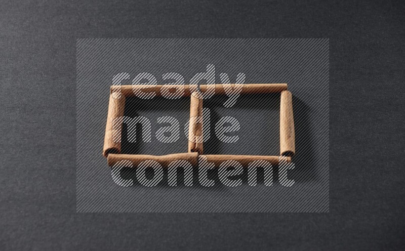 2 squares of cinnamon sticks on black flooring