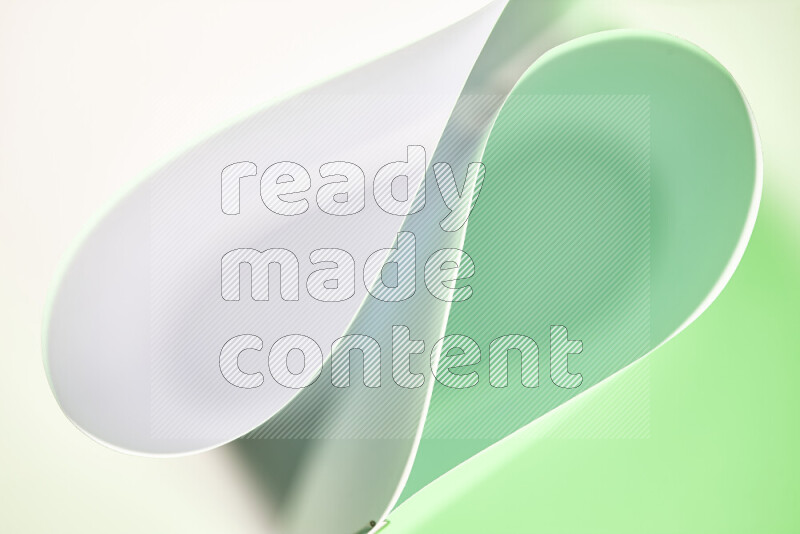 An abstract art of paper folded into smooth curves in white and green gradients