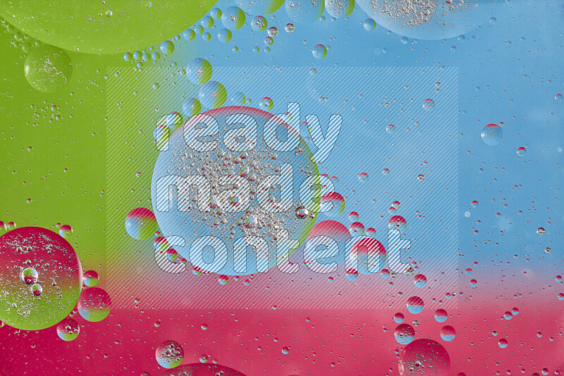 Close-ups of abstract oil bubbles on water surface in shades of pink, green and blue