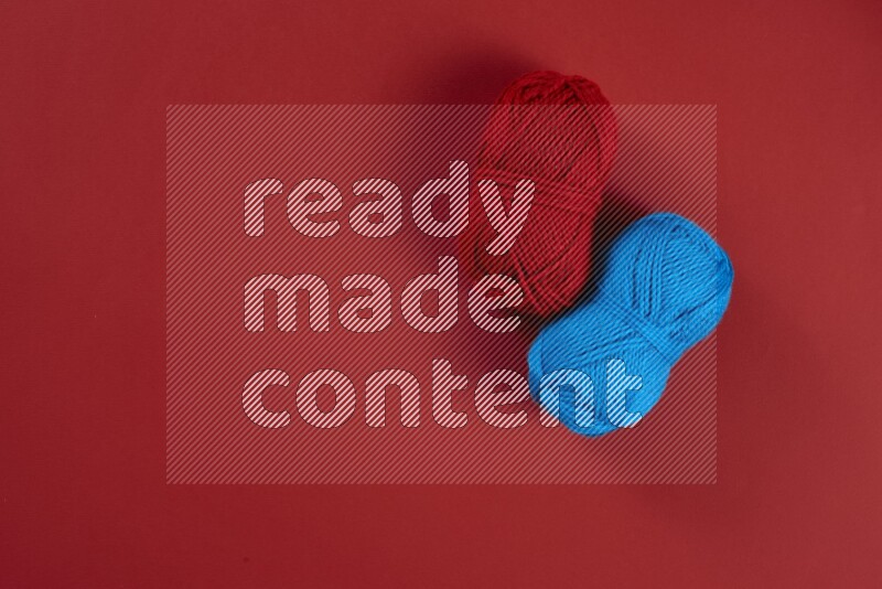 A blue and red collection of sewing and tailoring tools arranged on a red background