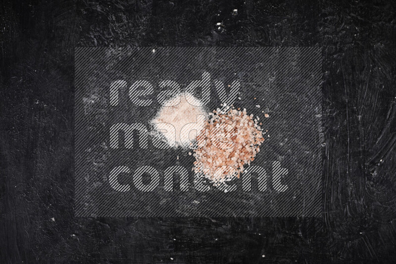 2 glass jars one is filled with fine himalayan salt and the other with coarse himalayan salt on black background