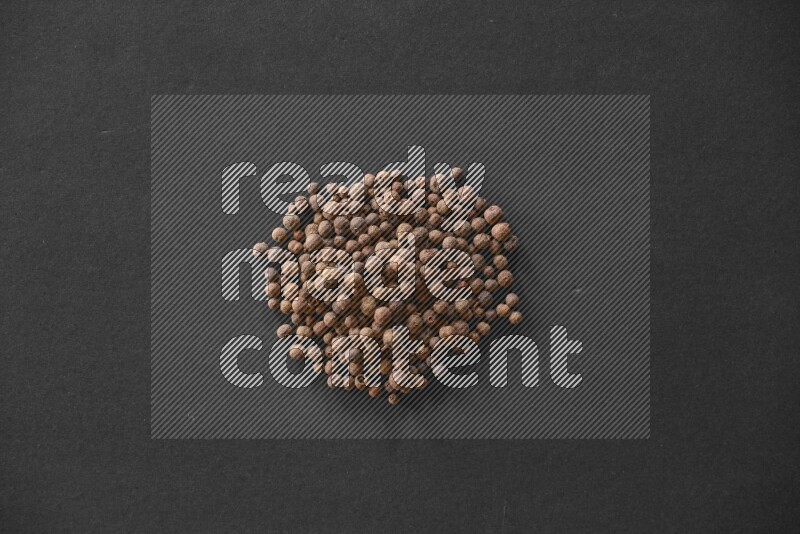 Allspice on a black flooring