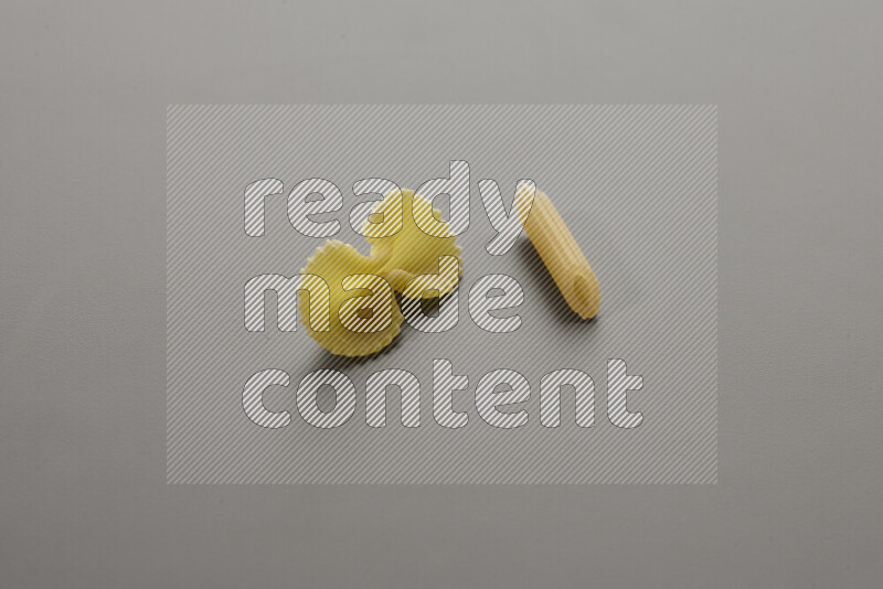Fiocchi pasta with other types of pasta on grey background