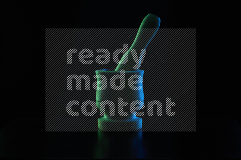 Wooden kitchen essentials with colored rim light against black background