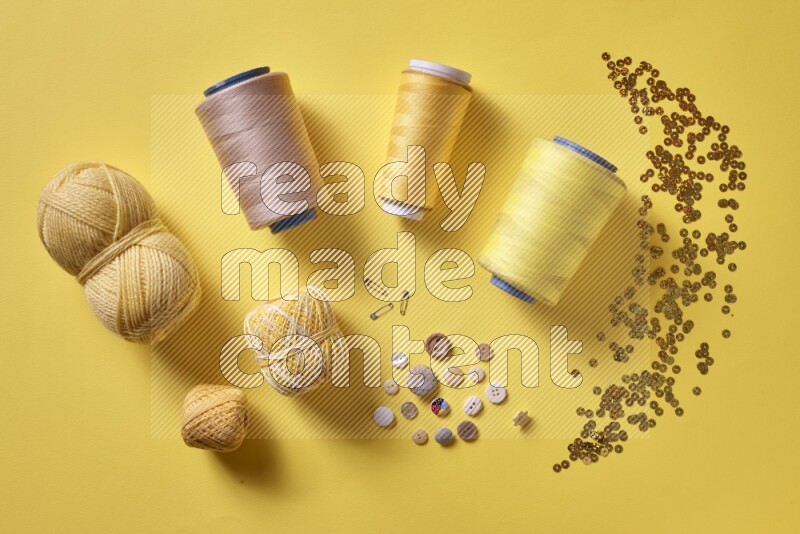 A yellow collection of sewing and tailoring tools arranged on a yellow background