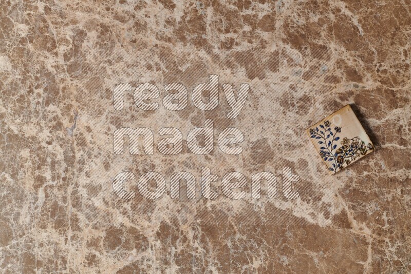 A decorative coaster on beige marble background