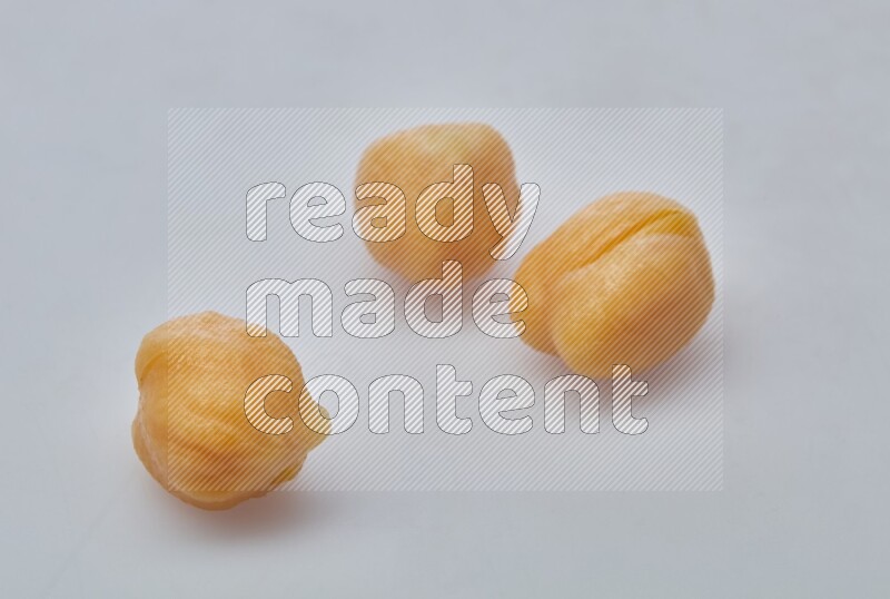 Close up of a boiled chickpeas in a container on white background