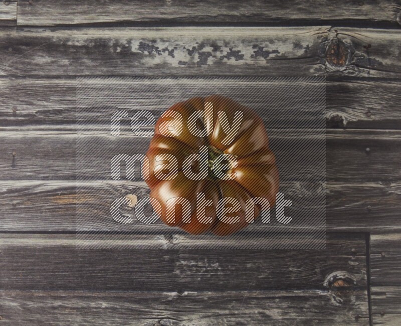 Single Tipview Heirloom Tomato on grey wooden background